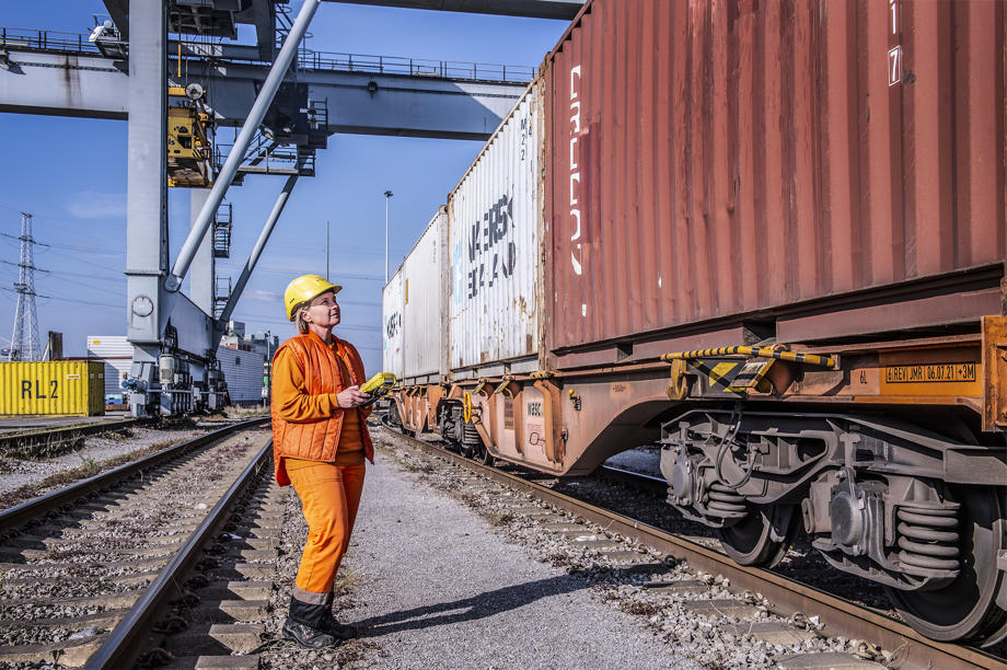 Photo of woman Rail Checker verifying the container numbers for imports and exports; validate the rail car ID.